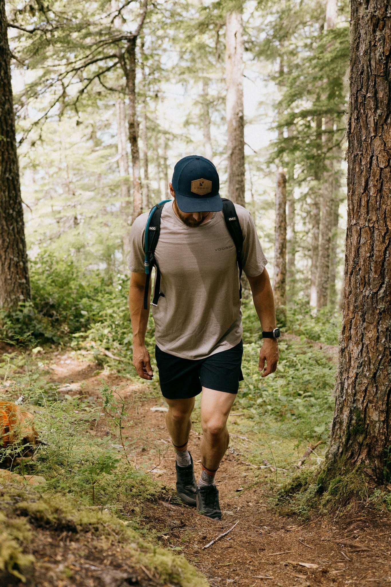 Man wearing VOORMI Short Sleeve Tech Tee hiking in the forest
