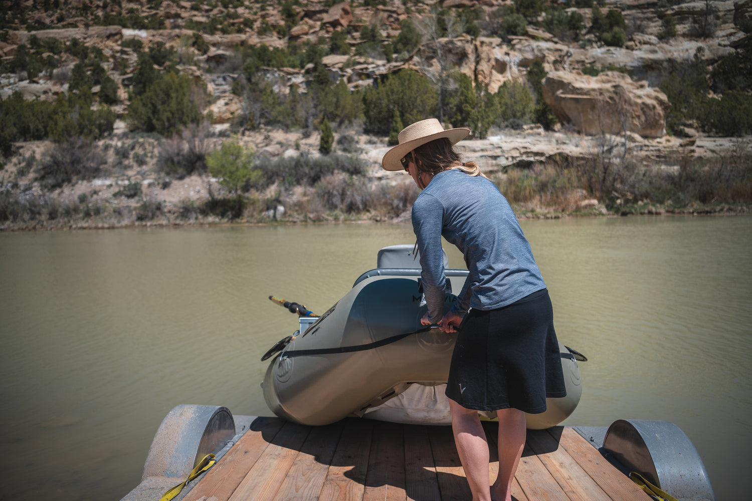 WOMAN'S SWIFT WATER SKIRT PULLING BOAT OUT OF RIVER